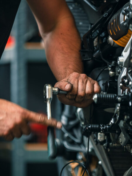 hands of professional person or mechanic working in workshop or