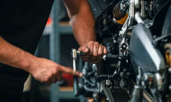 hands of professional person or mechanic working in workshop or